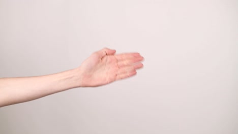 A-hand-on-the-left-side-doing-rock-paper-scissors-on-a-white-background