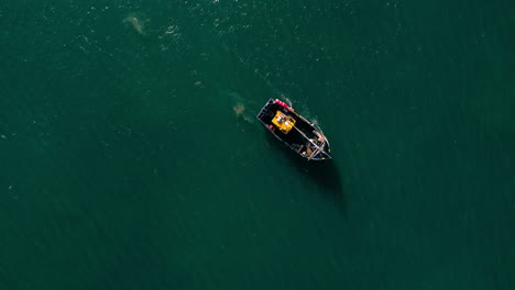 A-birds-eye-view-drone-shot-of-a-fishing-boat-off-the-coast-of-Devon-Uk