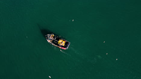 A-birds-eye-view-drone-shot-of-a-fishing-boat-off-the-coast-of-Devon-Uk