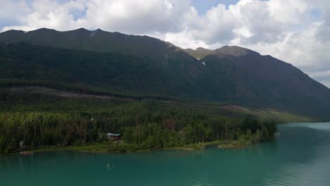 4K-Aerial-drone-footage-of-riverfront-open-water-and-mountains-in-Alaska-during-summertime