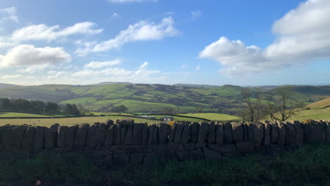 Rolling-hills-in-the-British-peak-district-countryside-in-England-with-a-stone-wall