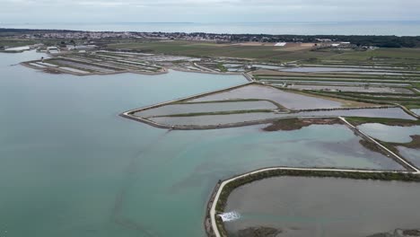Salt-marshes-in-the-Île-de-Ré-Island-in-Western-France-near-the-village-of-Loix,-Aerial-pan-left-shot