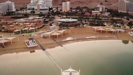 4K-Aerial-drone-dolly-shot-sunset-over-desert-dead-sea-hotel-zone