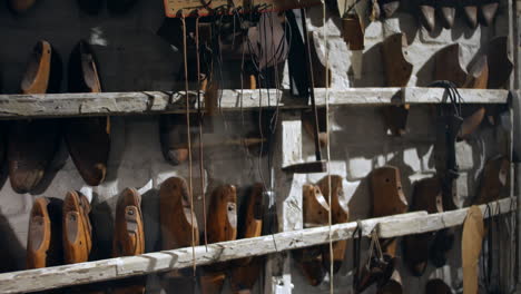 A-wall-of-vintage-shoe-lasts-in-a-footwear-cobbler-workshop