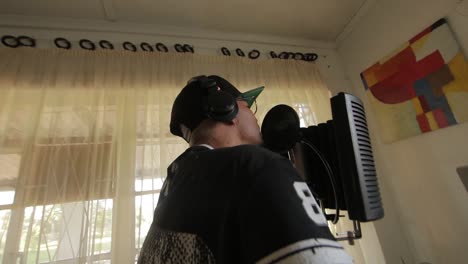 AFRICAN-GUY-SINGING-ONTO-A-MICROPHONE-AT-A-HOME-STUDIO