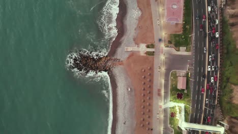 Topview-aerial-of-the-Lima-sea,-beach-and-road
