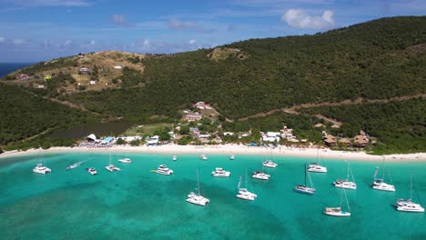 Aerial-View-of-White-Bay-and-Beach,-Belle-Vue,-British-Virgin-Islands,-Anchored-Boats-and-Yachts-in-Turquoise-Sea