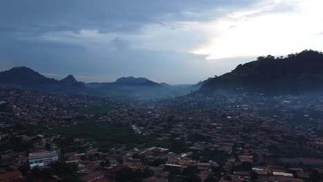 Flying-over-the-Etoug-Ebe-quarter,-foggy-morning-in-Yaounde,-Cameroon,-Africa---aerial-view