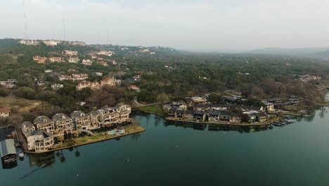 Suburban-Neighborhood-Condos-and-Homes-in-Westlake,-Austin-Texas-on-Lake-Austin-Aerial-orbit-at-sunrise-in-4k