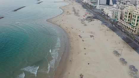 4k-Aerial---Blue-waves,-boardwalk---Tel-aviv-beach-during-sunset