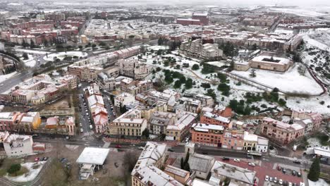Ancient-city-of-Salamanca-covered-in-snow-after-a-blizzard,-aerial-view