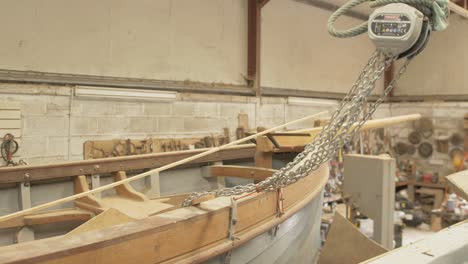 Shipwright's-boatshed-clinker-built-sailboat-under-construction