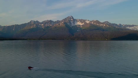 4K-Aerial-Drone-footage-near-Seward-Alaska-along-the-waterfront-in-summertime-with-a-boat-driving-by