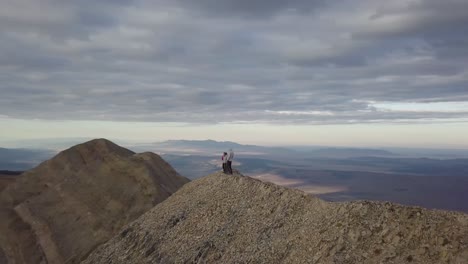 adventurers-hiking-to-the-top-of-mt-nebo-in-salt-lake-city-utah-with-a-panoramic-vista---AERIAL-TRUCKING-PAN