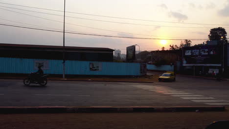 Traffic-in-the-suburbs-of-Yaounde-city,-sunny-evening-in-Cameroon,-Africa