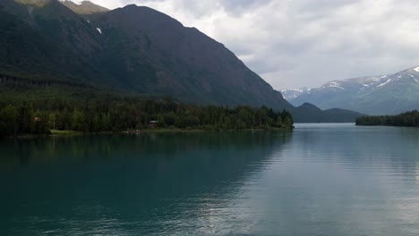 4K-Aerial-drone-footage-of-riverfront-open-water-and-mountains-in-Alaska-during-summer