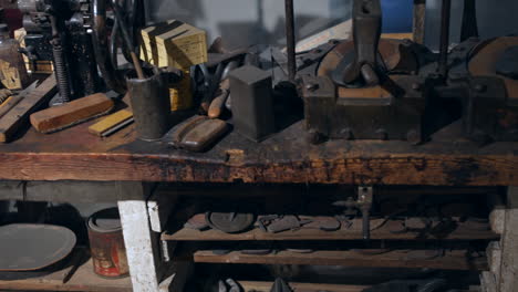 A-vintage-cobbler-shoe-making-workshop-with-tools-and-footwear