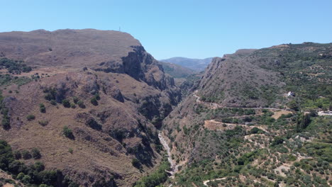 Drone-view-of-narrow-Topoliana-gorge-in-arid-mountains-of-Crete,-Greece