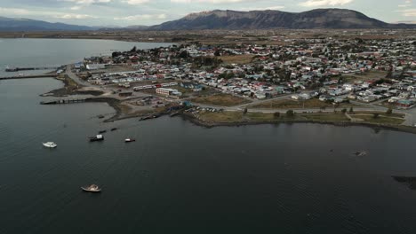 Puerto-Natales-Chile-Aerial-Cityscape-View-Above-Patagonian-Water-Coast,-Houses,-Streets,-Boats-in-Patagonian-Town,-Torres-del-Paine-National-Park