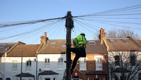 Telecommunication-engineer-working-on-cables-at-the-top-of-a-telephone-pole