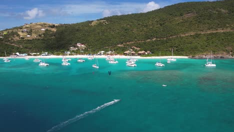 British-Virgin-Islands,-Aerial-View-of-Anchored-Boats-by-White-Sand-Beach-and-Coastline-of-Belle-Vue-Island