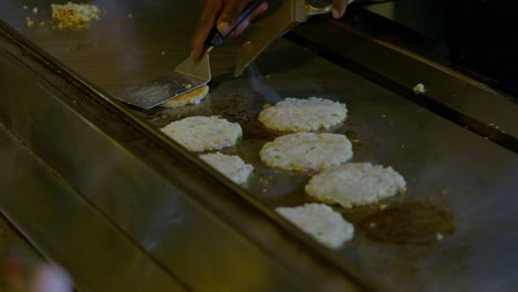 Close-Up-Of-Chef-Turning-Chicken-Piece-Being-Prepared-On-Grill