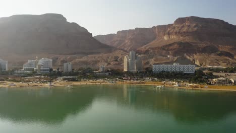 4K-Aerial-drone-dolly-out-rocky-mountains-near-the-dead-sea-hotel-zone