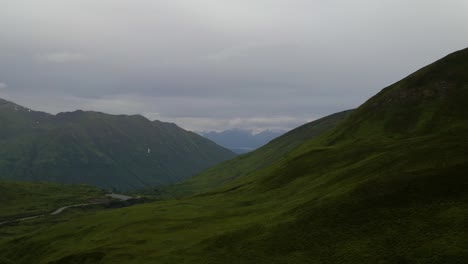 4k-aerial-drone-footage-of-mountains-outside-of-palmer-alaska-in-summer-on-a-cloudy-day-with-rain