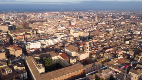Aerial-pullback-panoramic-cityscape-view-over-Parma,-Emilia-Romagna,-Italy