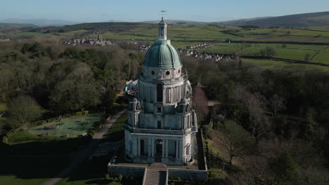 Ashton-Memorial-monument-in-Williamson-Park-Lancaster-UK-pan-down-westerly-aspect-revealing-green-fields-and-M6-motorway