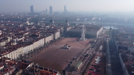 Aerial-panning-shot-of-Bellecour-square-in-Lyon-French-city-with-scenic-morning-sunlight