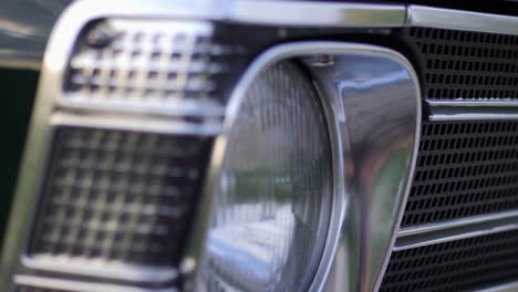 Opel-Olympia-classic-car-front-lamp-with-Opel-logo,-parallax-shot,-50-fps-slow-motion