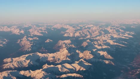 Aerial-view-of-the-sunrise-over-the-snow-capped-European-Alps