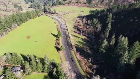 Beautiful-4K-aerial-drone-shot-overlooking-freeway-and-little-farm-in-Southern-Oregon