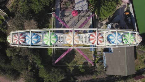 Ferris-wheel-spins-in-a-small-theme-park---top-down-shot