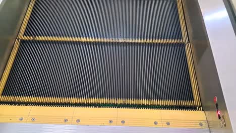 Simple-escalator-with-yellow-line-Moving-up