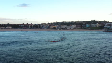 Ocean-ski-kayakers-paddle-out-into-Bondi-bay-during-the-early-morning,-Sydney-Australia
