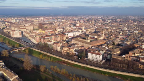Aerial-view-flying-across-Parma-Romanesque-Italian-city-landscape-during-sunrise