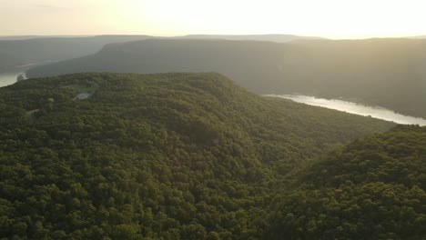 Tennessee-River-running-through-the-Appalachian-Mountains-during-golden-sunset,-aerial-drone-view