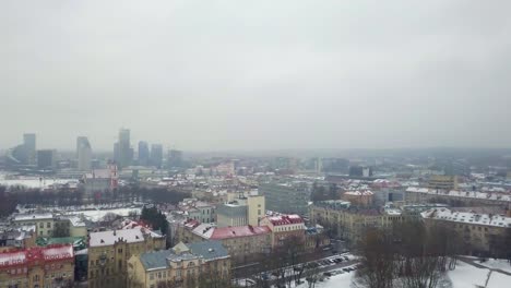 Aerial-panoramic-shot-over-the-city-of-Vilnius-during-a-snow-storm