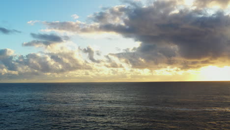 Aerial-drone-shot-of-a-cloudy-sunrise-over-the-ocean-near-Bondi-Austraia