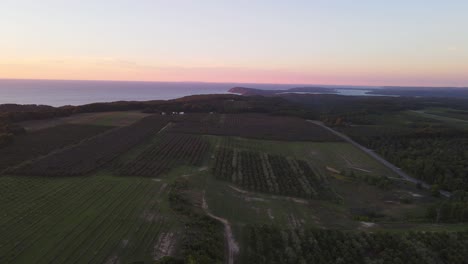 Aerial-flyover-of-farmland-on-the-Leelanau-Peninsula-near-Sleeping-Bear-Dunes-National-park-and-National-Lake-shore-at-sunset