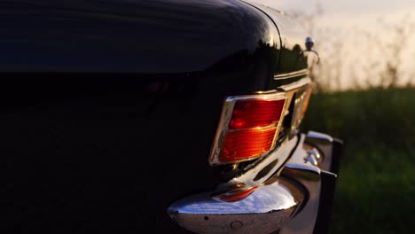 Opel-Olympia-classic-car-trunk-side-shot-during-sunset-on-a-slider,-50-fps-slow-motion