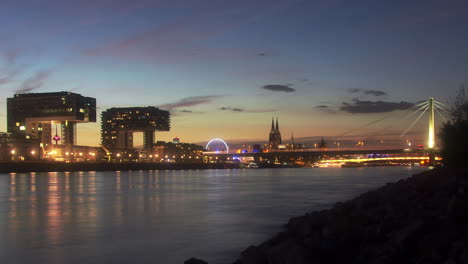 Colorful-day-to-night-timelapse-of-colognes-Crane-Houses-and-rhine-river-in-the-foreground