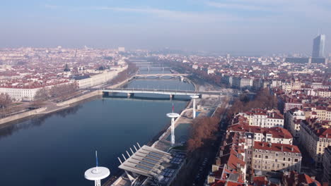 Aerial-tilt-up-over-Saone-river-crossing-Lyon-city-at-day-time