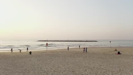 4k-Luftaufnahme-–-Majestätische-Dolly-Menschen-Am-Strand-Von-Tel-Aviv-Bei-Sonnenuntergang