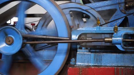 Blue-vintage-industrial-steam-engine-machine-rotating-fast