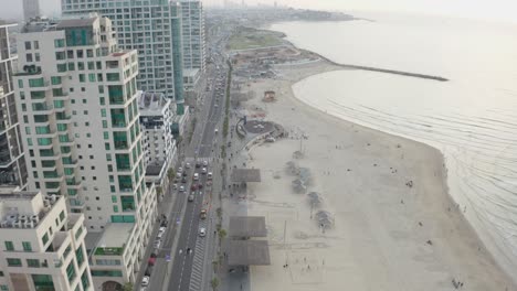 4k-Aerial---Majestic-cityscape-and-boardwalk---Tel-aviv-beach-during-sunset