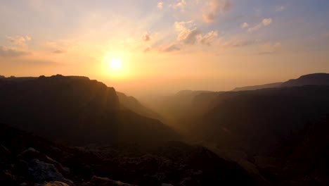 Time-lapse-of-sunset-over-Dana-Biosphere-Reserve-and-Rift-Valley-in-Jordan,-epic-rugged-mountainous-canyon-view-in-Middle-Eastern-landscape