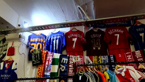 Panning-shot-of-iconic-football-shirts-for-sale-in-a-vintage-street-market-in-Shoreditch